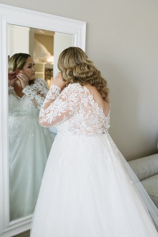 Bridal hair styled at the mirror
