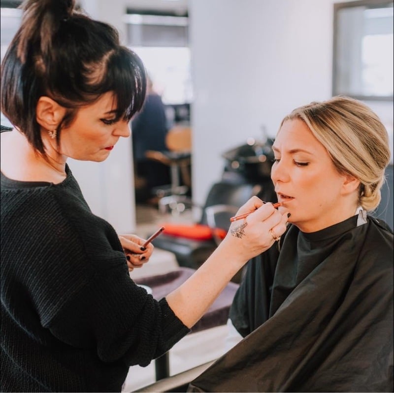 Kelly Cunningham applying a client's makeup on location